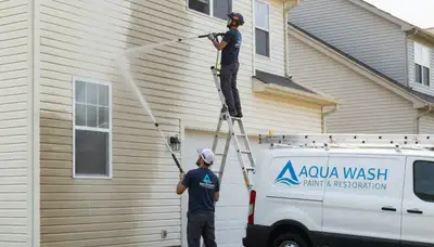 Pasadena, CA painters pressure cleaning vinyl siding to remove dirt, algae, and oxidation